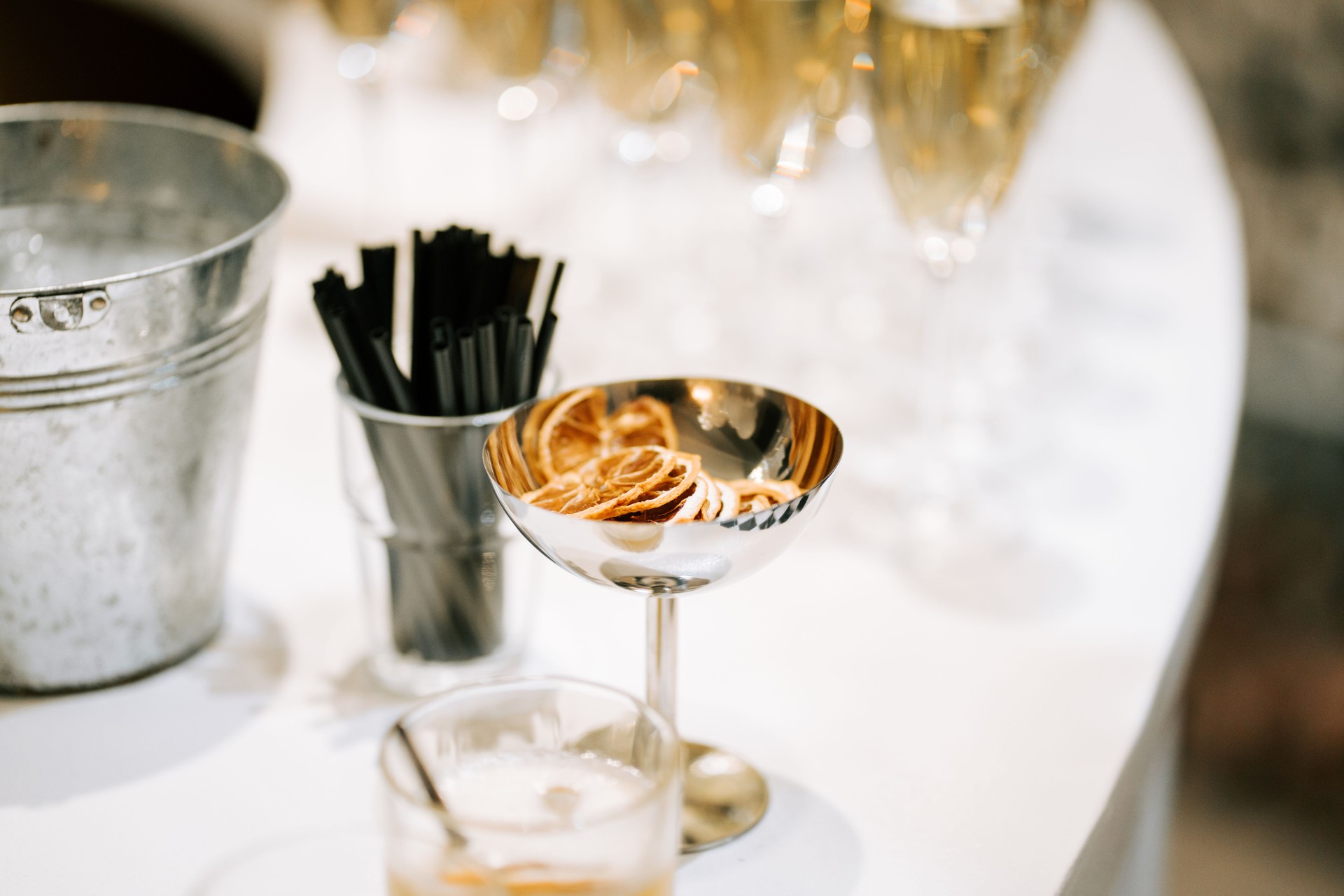 Elegant cocktail setup with garnishes and champagne flutes at a festive gathering